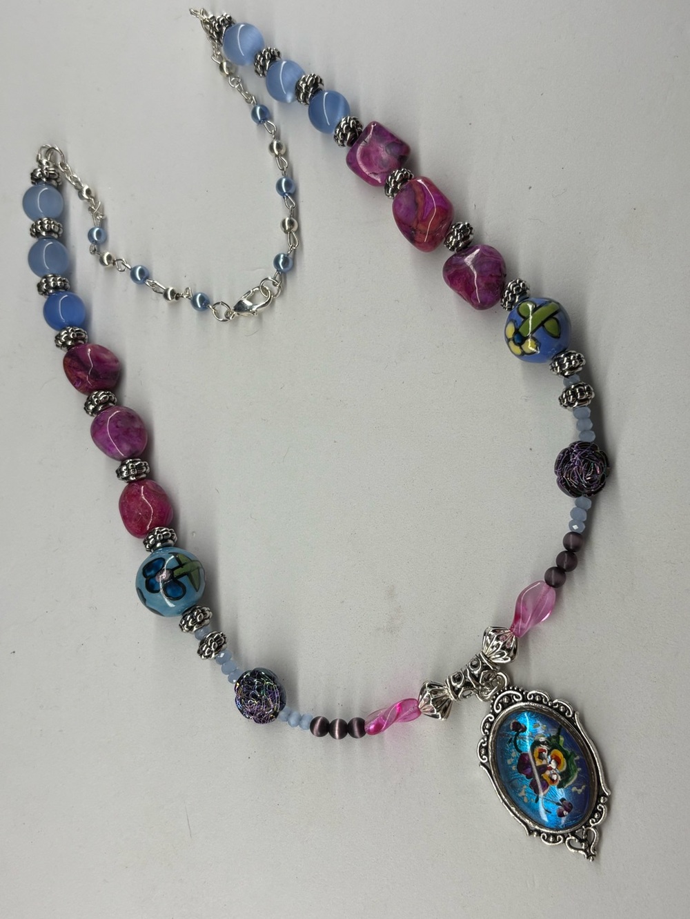 “Butterfly Effect” - Butterfly Wing Pendant,Painted Flower, Ceramic,Cat’sEye